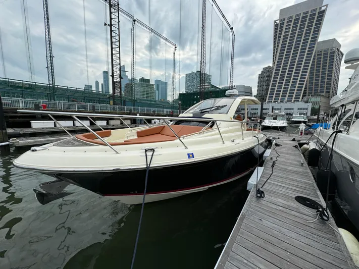 Ufo Yacht Photos Pics 2018 Chris-Craft Launch 38 docked at a marina with city skyline backdrop.