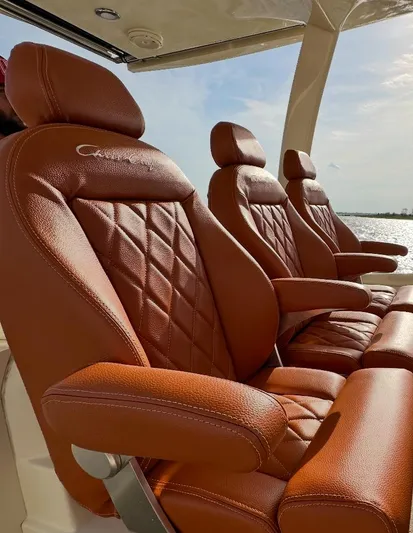 Ufo Yacht Photos Pics Luxurious leather seats on a 2018 Chris-Craft Launch 38 boat, featuring elegant diamond stitching.