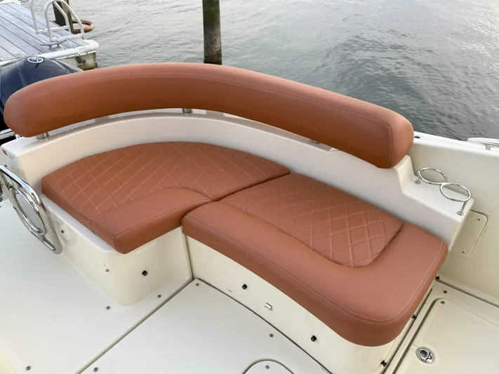 Ufo Yacht Photos Pics Luxurious seating on 2018 Chris-Craft Launch 38 boat, featuring elegant brown upholstery.