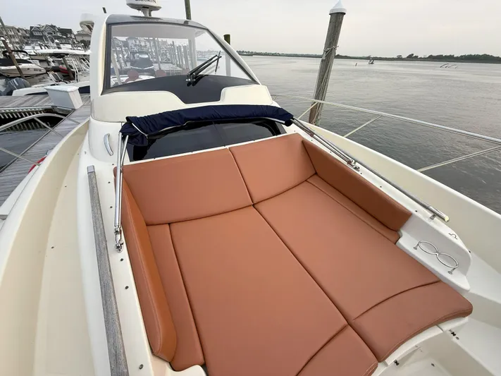 Ufo Yacht Photos Pics 2018 Chris-Craft Launch 38 with tan leather seating, docked by the water.