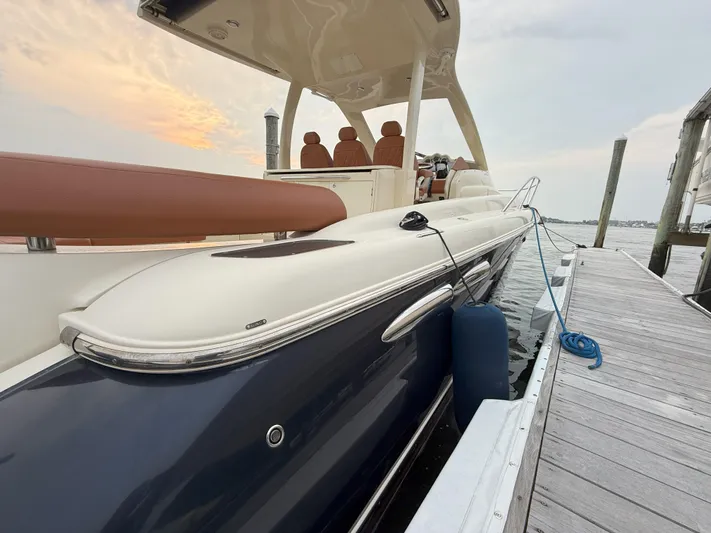 Ufo Yacht Photos Pics 2018 Chris-Craft Launch 38 docked, showcasing sleek design and luxurious seating.