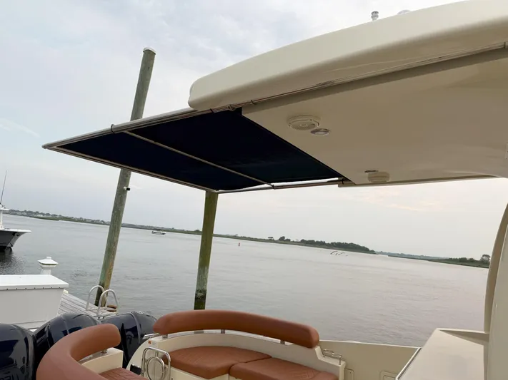 Ufo Yacht Photos Pics 2018 Chris-Craft Launch 38 with retractable awning, docked by a serene waterfront.