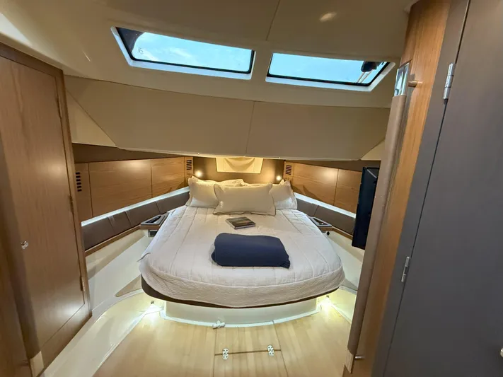 Ufo Yacht Photos Pics Luxurious cabin interior of 2018 Chris-Craft Launch 38 with skylights and cozy bedding.