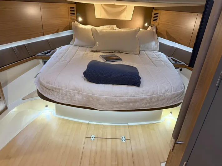 Ufo Yacht Photos Pics Luxurious cabin interior of 2018 Chris-Craft Launch 38 with cozy bedding and ambient lighting.