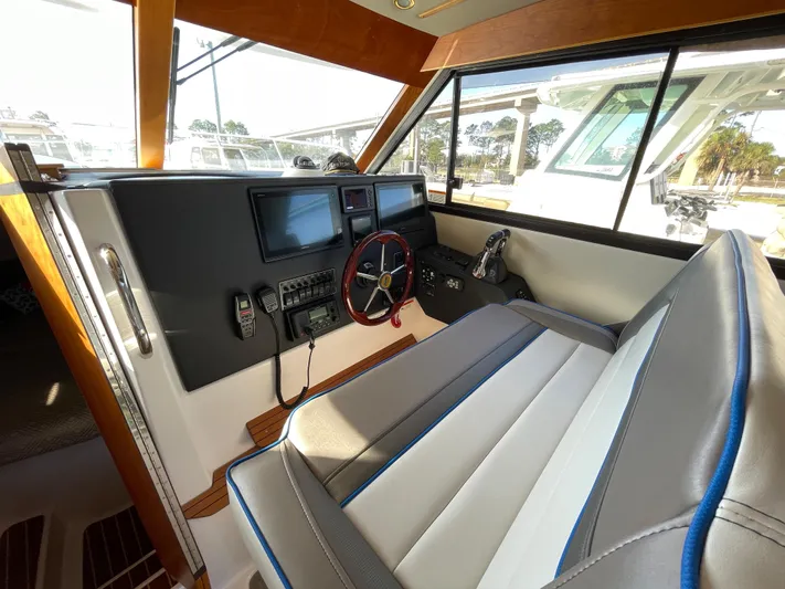  Yacht Photos Pics 2019 Cutwater C-302 Coupe interior with modern dashboard and comfortable seating.