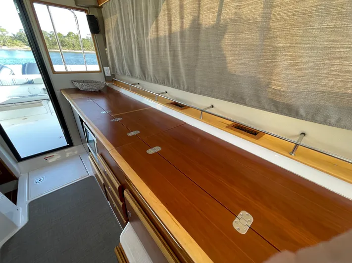  Yacht Photos Pics 2019 Cutwater C-302 Coupe interior with wooden cabinetry and large windows.
