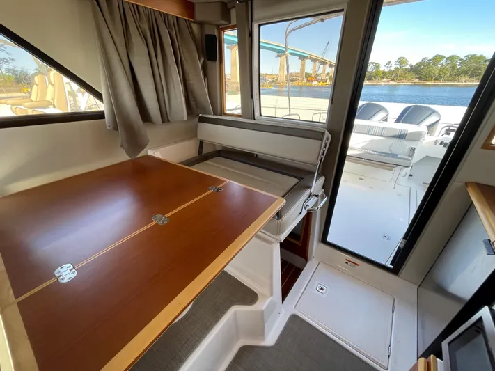  Yacht Photos Pics 2019 Cutwater C-302 Coupe interior with dining area and view of the deck and water.