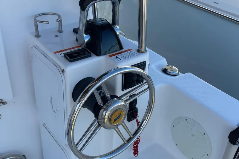  Yacht Photos Pics Steering wheel of a 2019 Cutwater C-302 Coupe boat, featuring sleek controls and modern design.