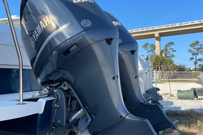  Yacht Photos Pics 2019 Cutwater C-302 Coupe with dual Yamaha outboard engines, parked near a bridge.