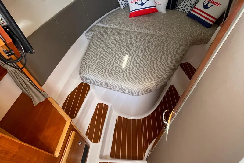  Yacht Photos Pics 2019 Cutwater C-302 Coupe cabin interior with bed and wooden flooring.