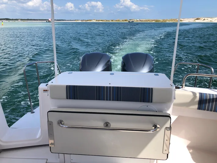  Yacht Photos Pics 2019 Cutwater C-302 Coupe cruising on open water, featuring dual engines and a sleek design.