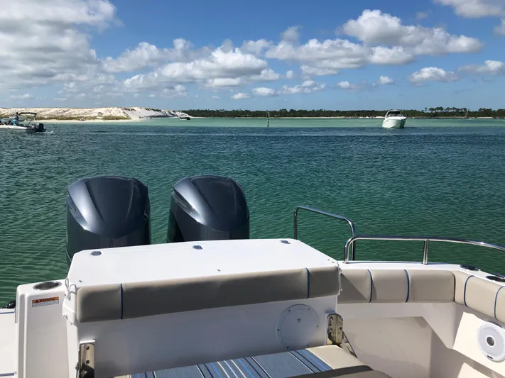  Yacht Photos Pics 2019 Cutwater C-302 Coupe on serene water with clear skies and distant boats.