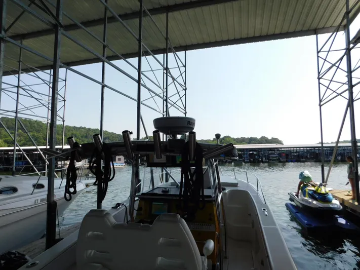 Fountain Repowered Yacht Photos Pics 2004 Fountain 38 Sportfish CC docked under a covered marina.