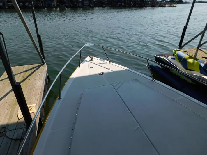 Fountain Repowered Yacht Photos Pics 2004 Fountain 38 Sportfish CC boat docked on calm water.