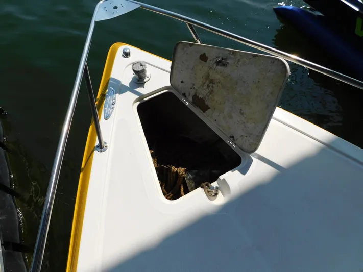 Fountain Repowered Yacht Photos Pics 2004 Fountain 38 Sportfish CC boat with open storage compartment on deck.