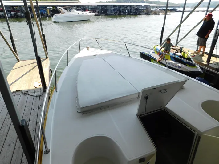 Fountain Repowered Yacht Photos Pics 2004 Fountain 38 Sportfish CC boat docked, with open deck and nearby jet ski.