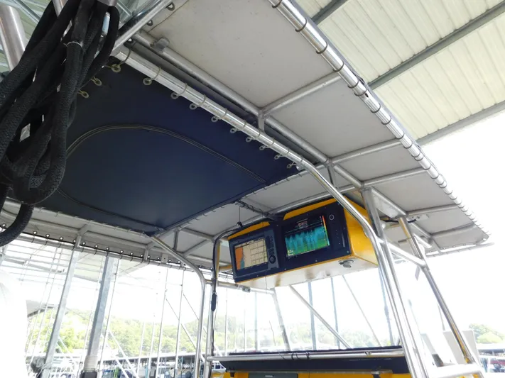 Fountain Repowered Yacht Photos Pics 2004 Fountain 38 Sportfish CC boat with canopy and electronic navigation equipment.