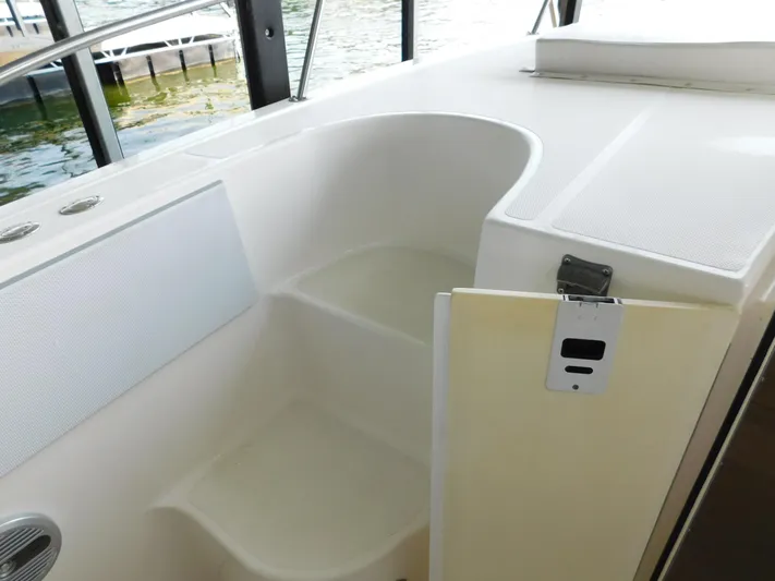 Fountain Repowered Yacht Photos Pics 2004 Fountain 38 Sportfish CC boat interior with seating and storage area.