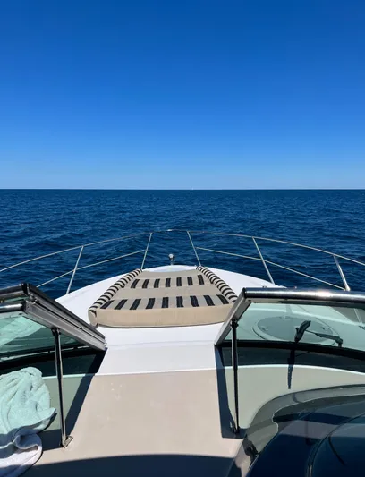 Lady June Yacht Photos Pics 2006 Four Winns 378 Vista yacht cruising on open sea under clear blue sky.