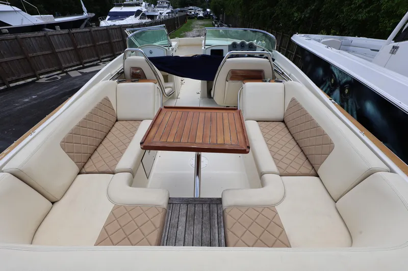 Yacht Photos Pics 2020 Chris-Craft 30 Launch boat interior with luxurious seating and wooden table.