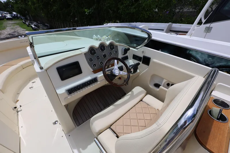  Yacht Photos Pics 2020 Chris-Craft 30 Launch boat cockpit with steering wheel and dashboard controls.