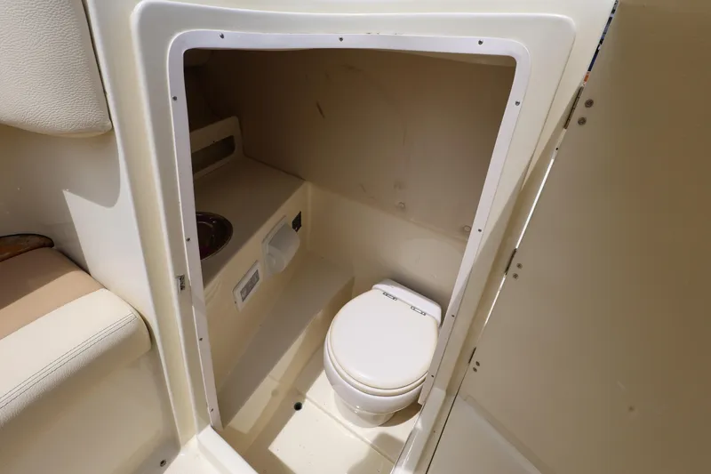  Yacht Photos Pics 2020 Chris-Craft 30 Launch boat interior with compact marine toilet.