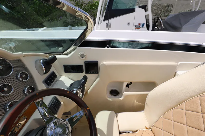  Yacht Photos Pics 2020 Chris-Craft 30 Launch boat interior with steering wheel and dashboard controls.