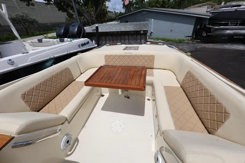  Yacht Photos Pics 2020 Chris-Craft 30 Launch boat interior with beige seating and wooden table.