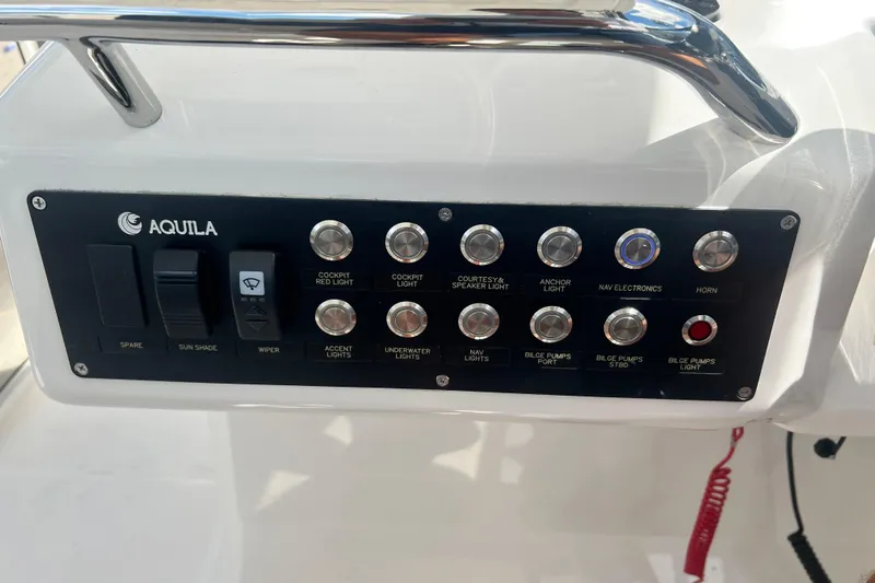  Yacht Photos Pics Control panel of 2025 Aquila 32 Sport boat with various switches and buttons.