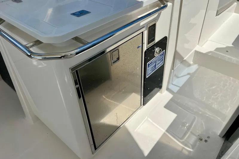 Yacht Photos Pics 2025 Aquila 32 Sport boat interior with stainless steel cabinet and sleek design.