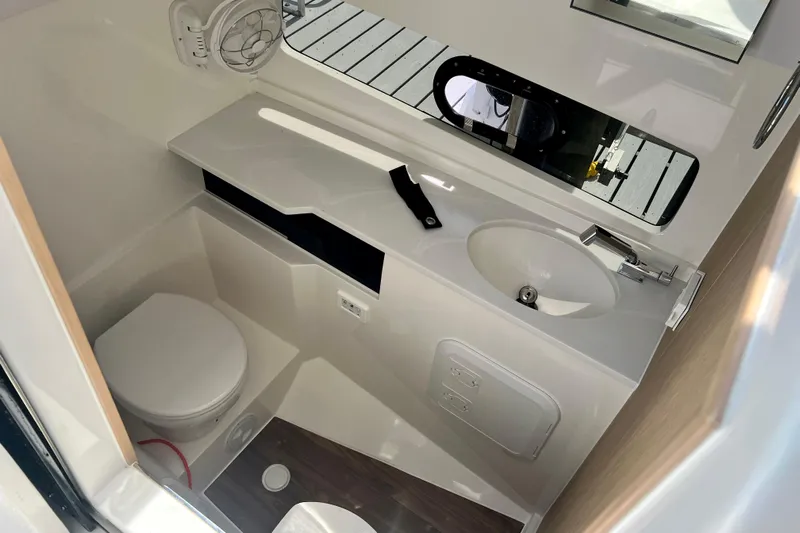  Yacht Photos Pics Modern bathroom interior of 2025 Aquila 32 Sport boat, featuring toilet and sink.