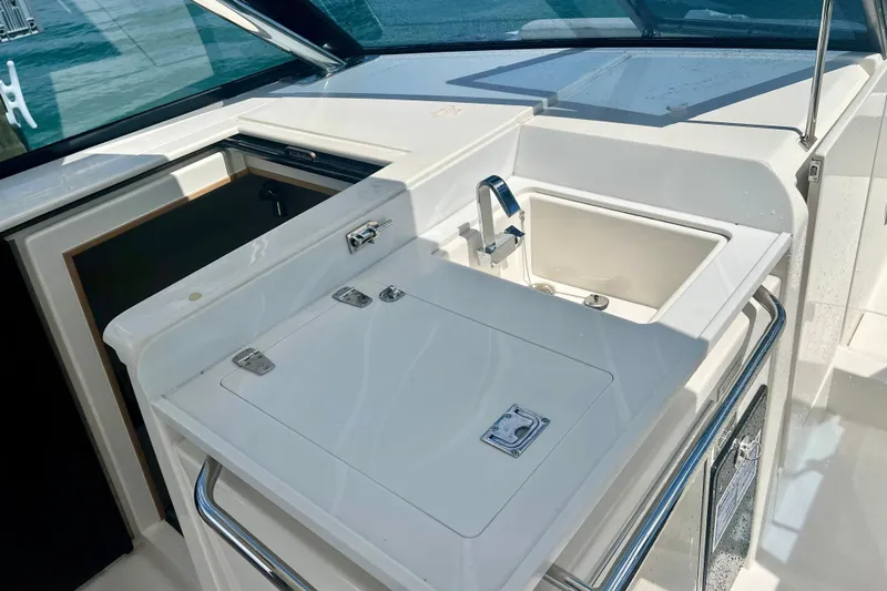  Yacht Photos Pics Aquila 32 Sport 2025 boat kitchenette with sink and storage compartments.