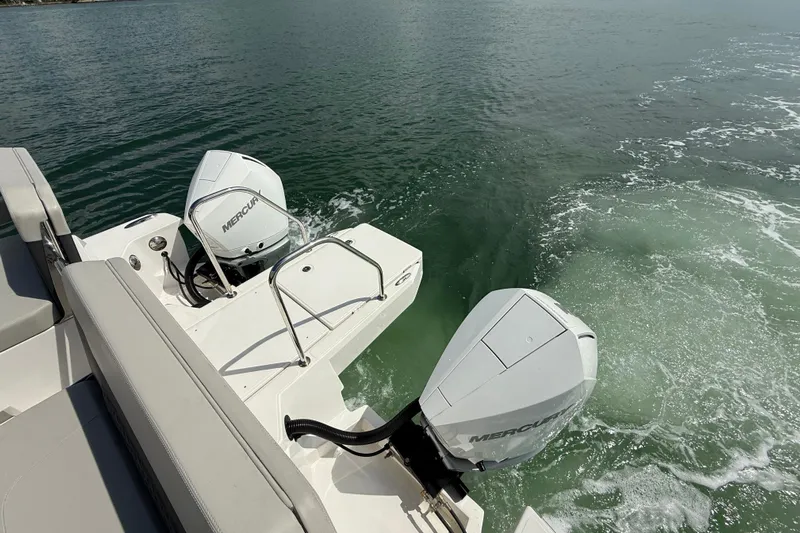  Yacht Photos Pics Aquila 32 Sport 2025 boat with dual Mercury outboard engines on water.