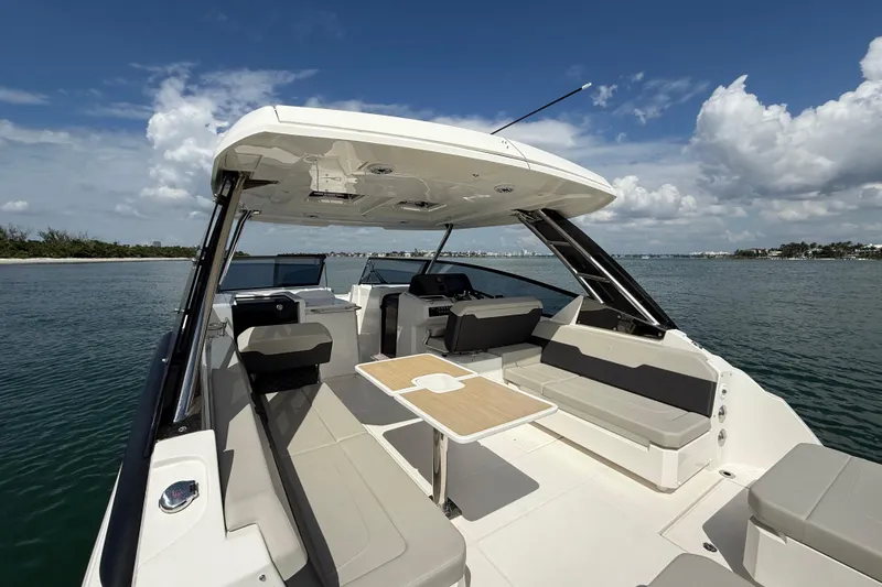  Yacht Photos Pics 2025 Aquila 32 Sport boat interior with seating and table on open water.