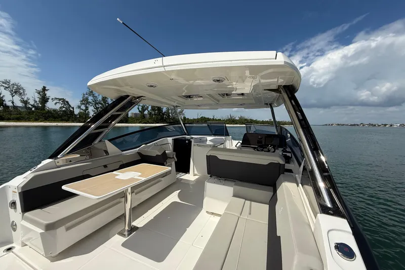  Yacht Photos Pics Aquila 32 Sport 2025 boat interior with seating and table on calm water.