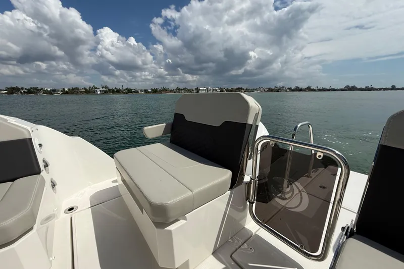  Yacht Photos Pics Aquila 32 Sport 2025 boat interior with seating, overlooking calm waters and cloudy sky.