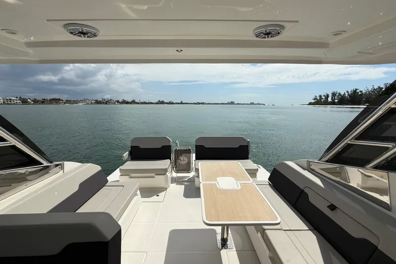  Yacht Photos Pics Aquila 32 Sport 2025 boat interior with seating and table, overlooking serene water view.