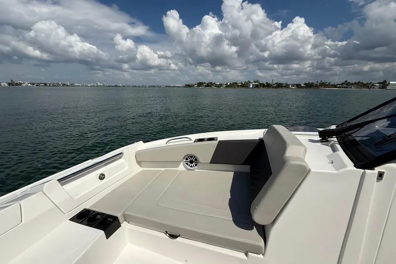  Yacht Photos Pics Aquila 32 Sport 2025 boat interior with seating, overlooking calm waters and cloudy sky.