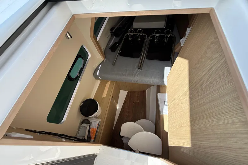  Yacht Photos Pics Interior view of 2025 Aquila 32 Sport boat, featuring modern design and wood accents.