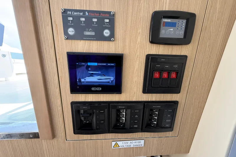  Yacht Photos Pics Control panel of 2025 Aquila 32 Sport boat with various switches and displays.