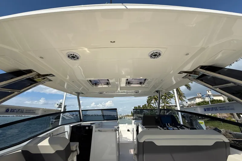  Yacht Photos Pics 2025 Aquila 32 Sport boat interior with modern design and ocean view.
