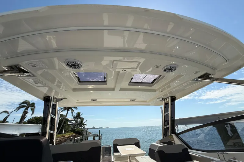  Yacht Photos Pics Aquila 32 Sport 2025 boat interior with ocean view, featuring a sleek roof design.