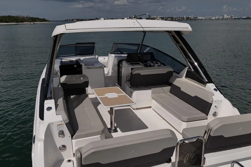  Yacht Photos Pics 2025 Aquila 32 Sport boat with spacious seating and modern design on calm waters.