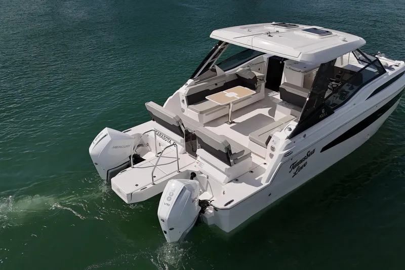  Yacht Photos Pics 2025 Aquila 32 Sport boat with dual Mercury engines on calm water.