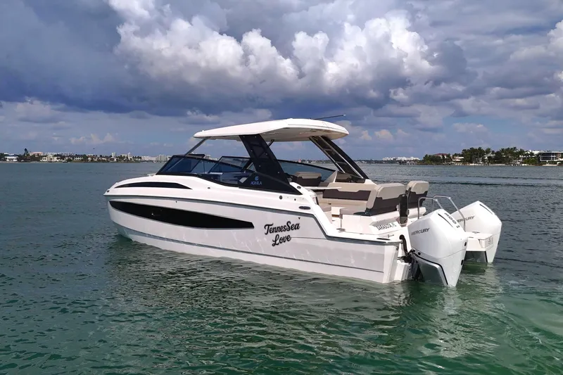  Yacht Photos Pics Aquila 32 Sport 2025 boat on water under cloudy sky.