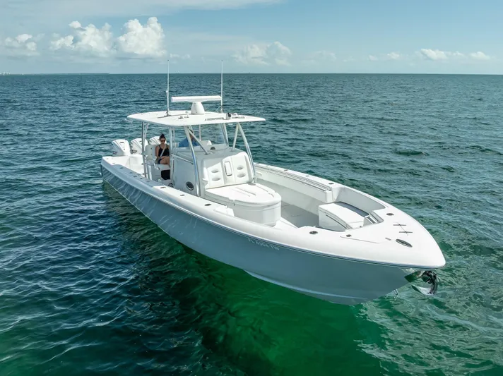  Yacht Photos Pics 2025 Contender 44 ST boat cruising on open sea under clear skies.