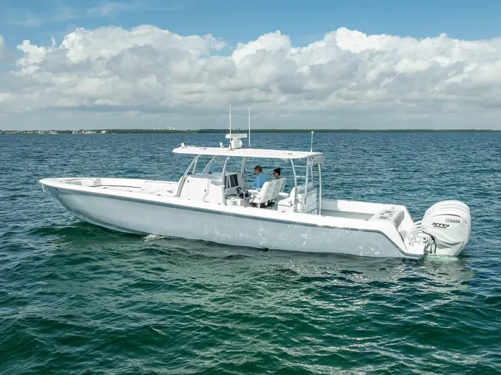  Yacht Photos Pics 2025 Contender 44 ST boat cruising on open water under a cloudy sky.