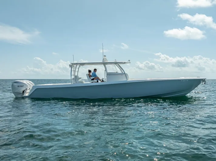  Yacht Photos Pics 2025 Contender 44 ST boat cruising on open water under a clear sky.