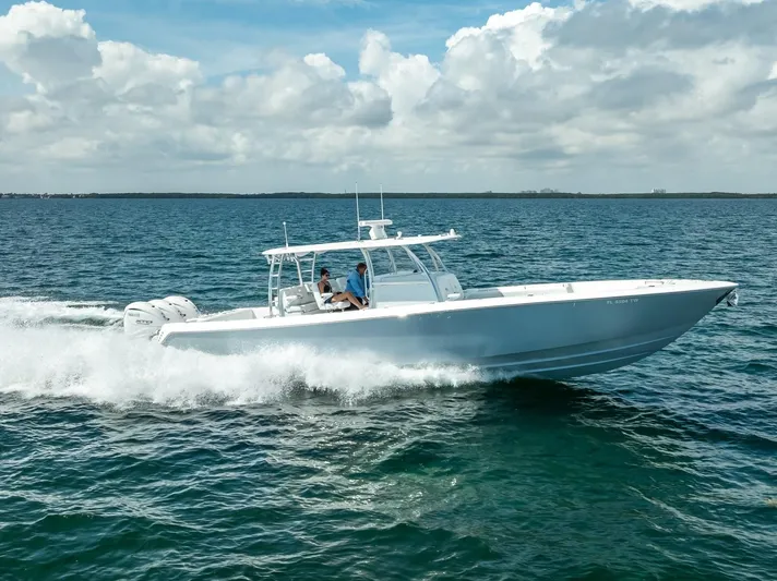  Yacht Photos Pics 2025 Contender 44 ST boat cruising on open water under a cloudy sky.