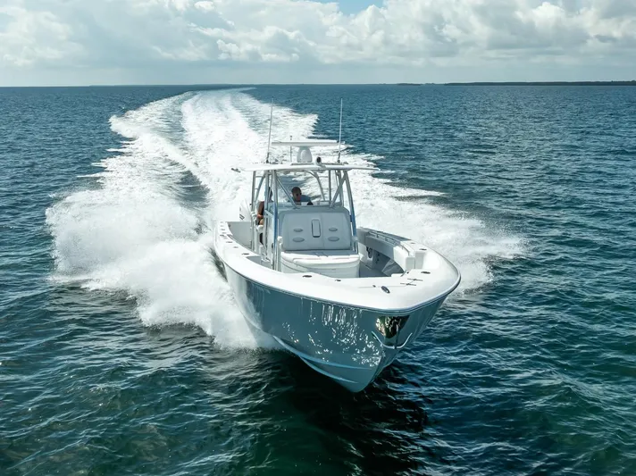  Yacht Photos Pics 2025 Contender 44 ST boat cruising on open water, leaving a wake behind.